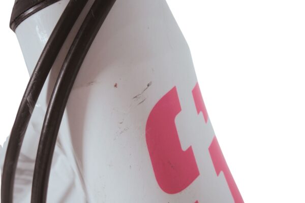 Kerékpárváz, rózsaszín logóval, kábelek láthatók.